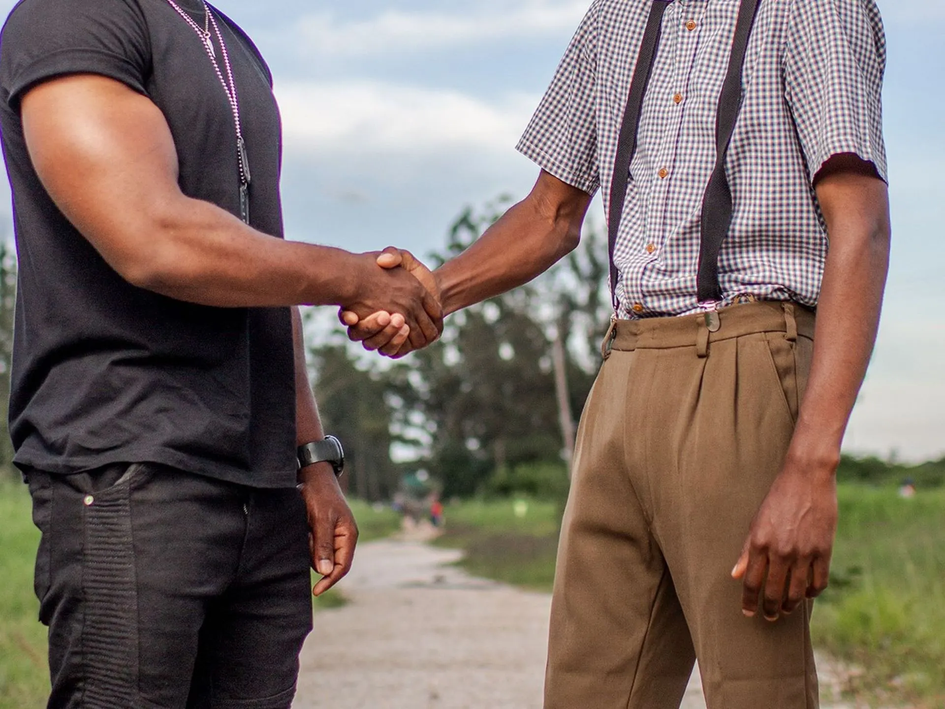 Poignée de main entre deux hommes en extérieur